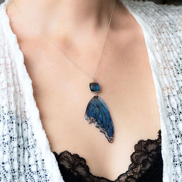 Femme portant le pendentif Lioraëlys avec aile bleue