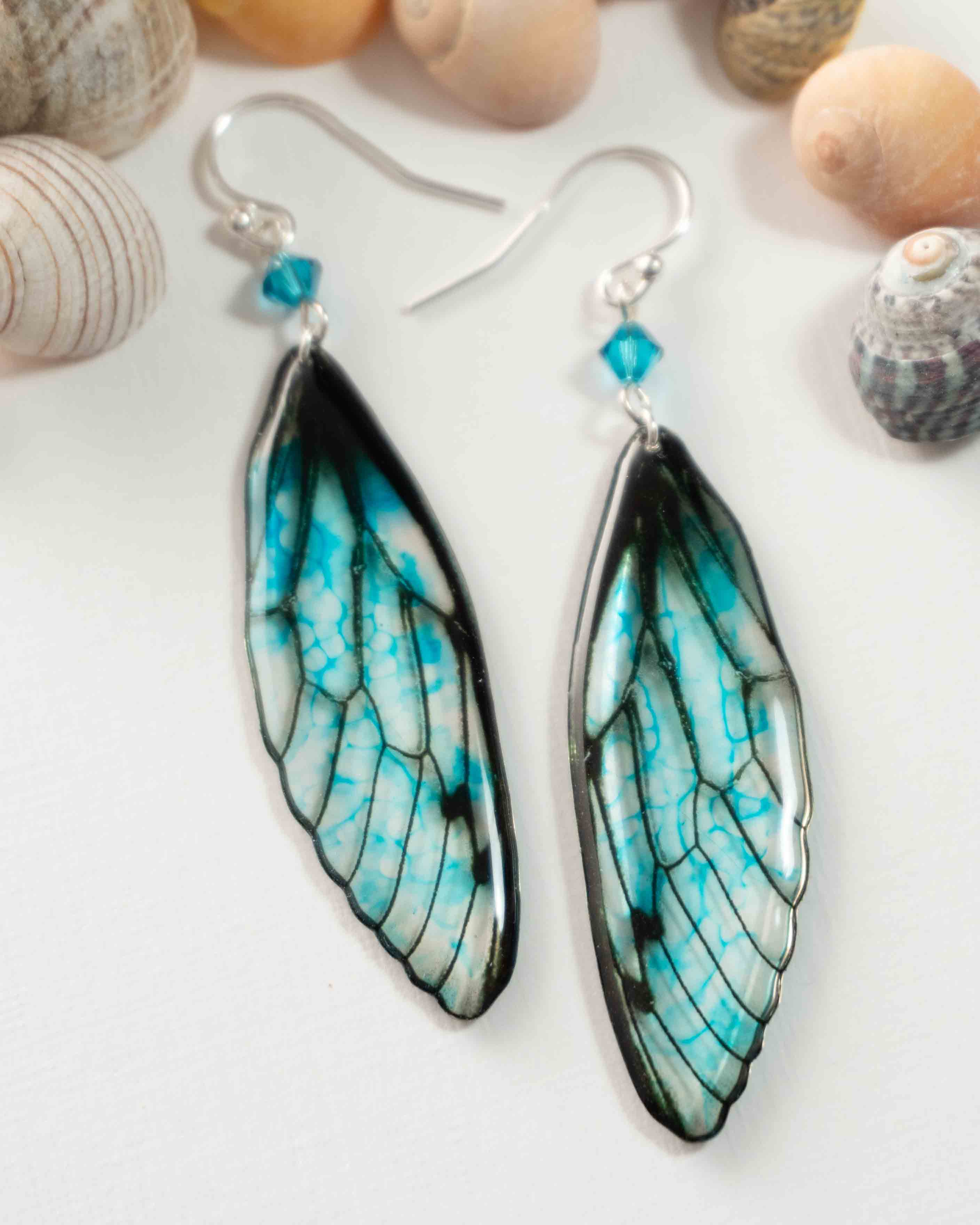 Boucles d’oreilles féeriques aux ailes turquoise et noires